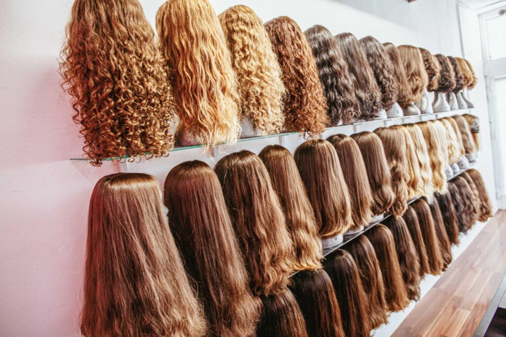 Wall display of human hair wigs at our wig store in Miami