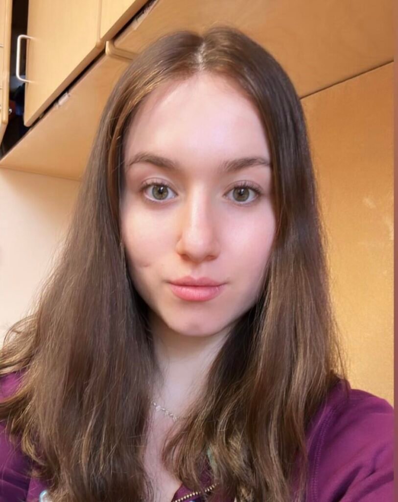 Woman in sweater wearing natural hair wig