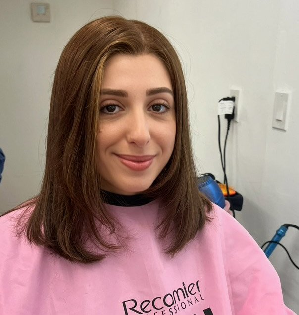 Daniella in hair robe wearing brunette custom wig in Miami salon