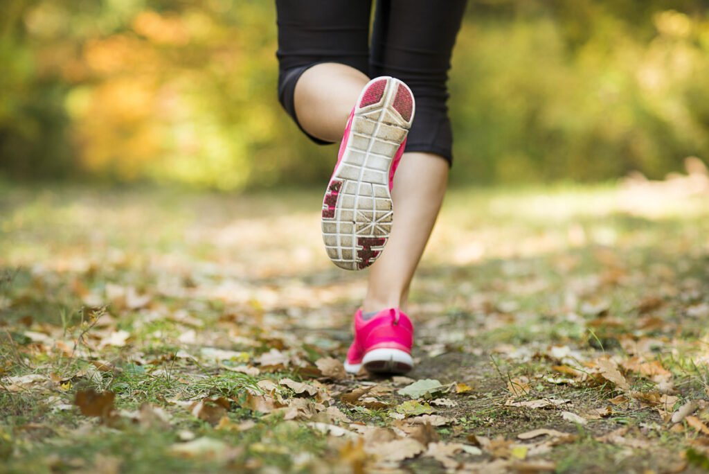 Woman runner in pink running shoes