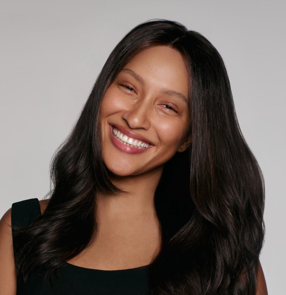Smiling woman wearing human hair wig